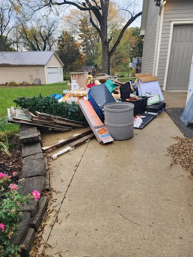 Dumpster being loaded with debris for 12 Yard Dumpster Rental in Covington